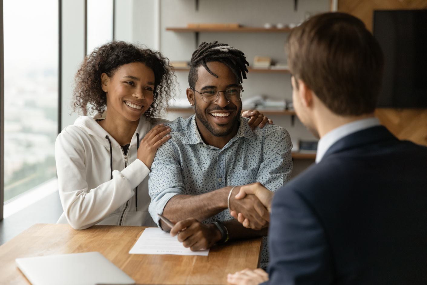 African Couple Shake Hand with Realtor